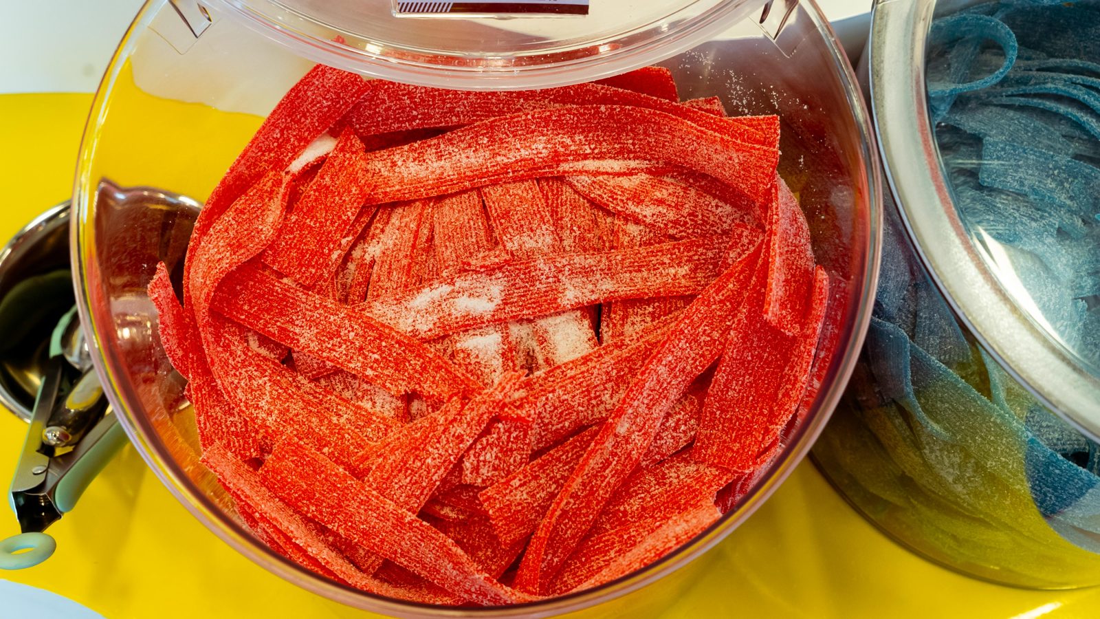 Blue raspberry sour belts in a large candy jar