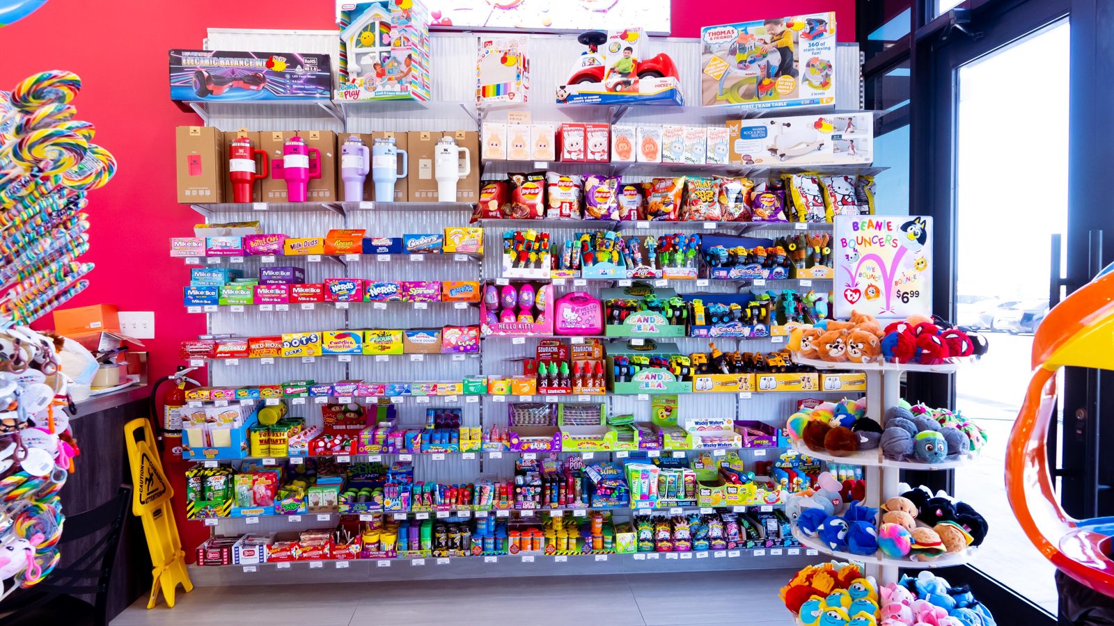 Floor-to-ceiling wall of packaged candy at Sugar Me Up